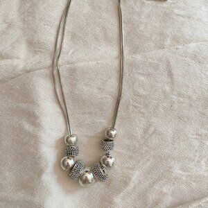 Double strand silver toned beaded necklace.